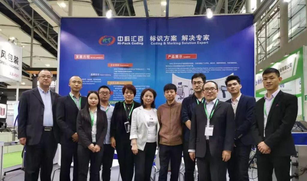 中科汇百展台蓝色布景前的多人合影